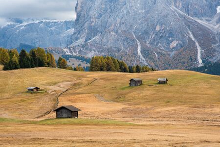 Beautiful mountain wooden chalets at the famous Alpe di Siusi valley on the Dolomites, South Tyrol...