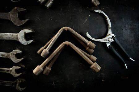 Details of a Group of metal Spanner heads of various sizes used to provide grip and mechanical advantage in applying torque to turn objects on a black backgroundの写真素材