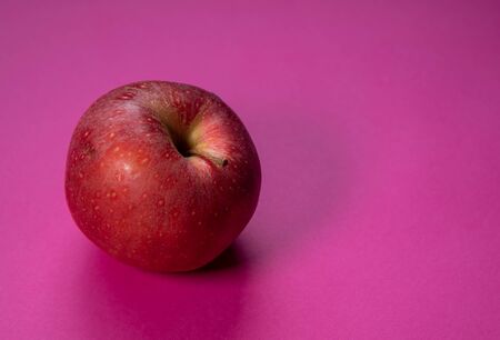 Rotten apple fruit isolated on a magenta backgroundの写真素材