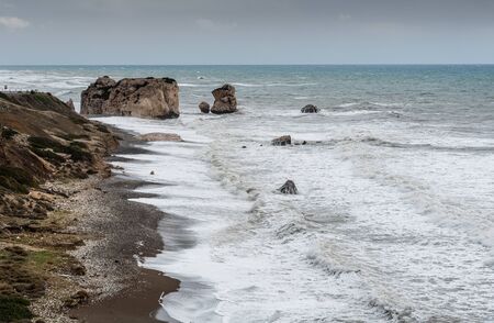 Seascape with windy waves during storm weather at the rocky coastal area of the Rock of Aphrodite in Paphos area, Cyprus.の写真素材