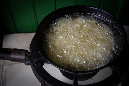 French fries potatoes boiled and cooked on a saucepan with oil and served crispy and tasty.の写真素材