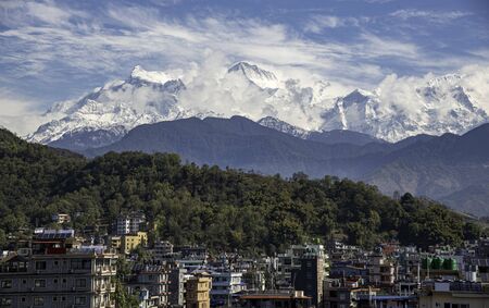 The cityscape of Pokhara  with the Annapurna mountain range covered in snow at central Nepal, Asiaの写真素材