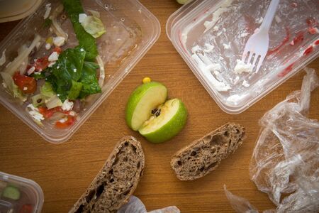 The remains of a food including salad, apple bread and dessertの写真素材