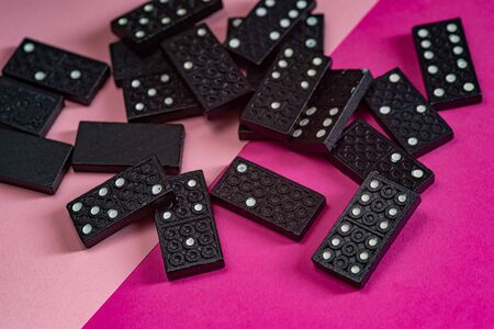 Black Dominoes game block on a colored backgroundの写真素材