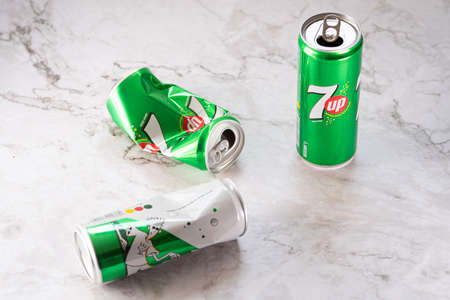 Nicosia, Cyprus -  March 01, 2020: Two smashed empty aluminium 7up tin cans ready for recycling