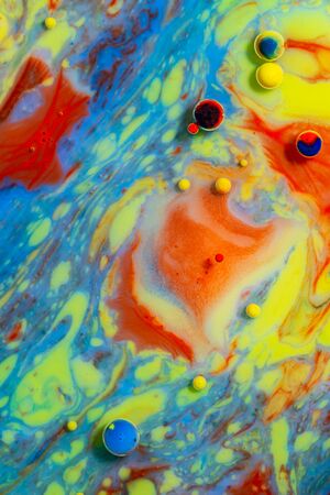 Colorful artistic background with various colors mixed with oil and milk