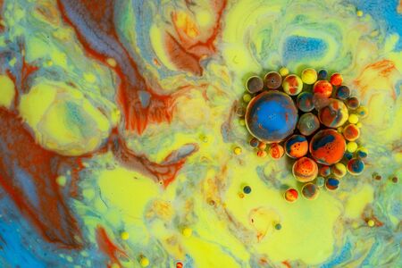 Colorful artistic background with various colors mixed with oil and milk