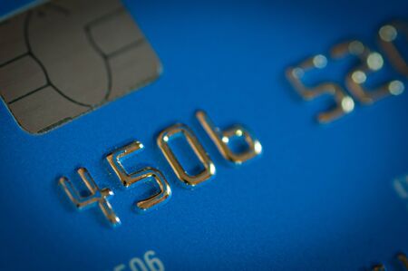 Close-up details of a blue credit card. Plastic money expensesの写真素材