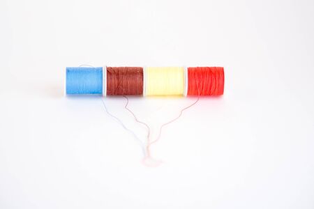 Colorful sewing thread reels isolated on a white background. Fashion and textileの写真素材
