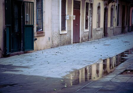 Old houses reflected on water in a neighbourhood at barceloneta old city district in Barcelona Spainの写真素材