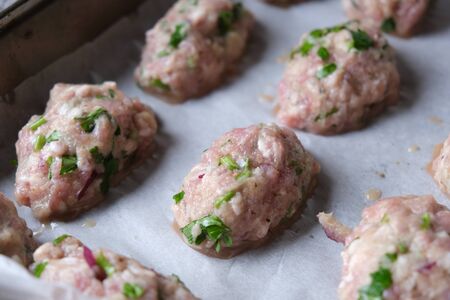 Fresh and uncooked raw healthy meat balls ready to be cooked on the oven.