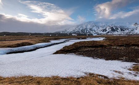 Typical Icelandic landscape with mountains and meadow land covered in snow at snaefellsnes peninsula in Icelandの写真素材