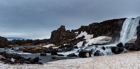 Water from waterfall splashing on a rocky river. The Oxararfoss waterfall in pingvellir Thingvellir national Park icelandの写真素材