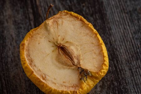 Yellow wilted rotten half apple details.