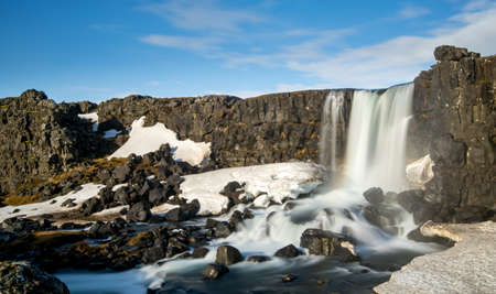 Water from waterfall splashing on a rocky river at the Oxararfoss waterfall in Thingvellir national...