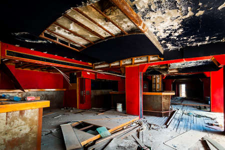 Abandoned interior of the bar of a restaurant with damaged stage and collapsing roof in Nicosia, Cyprusの写真素材