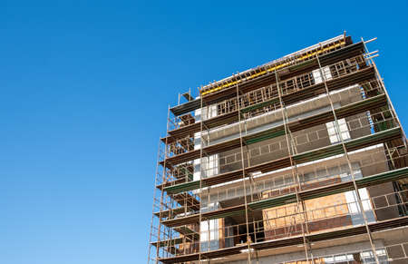residential building construction site against a blue clear sky
