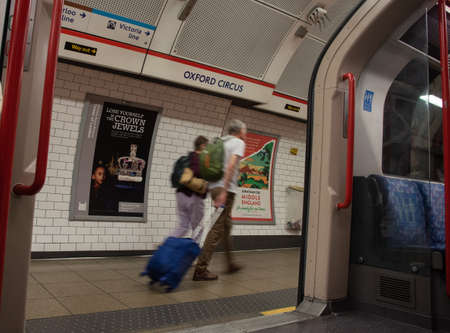 Random people at the underground tube station with Moving train motion blurred in london, UKのeditorial素材
