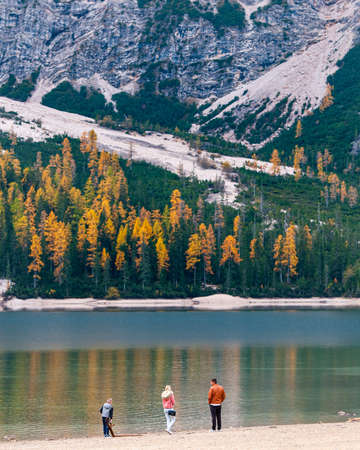 People enjoying the Lago di Braise in the dolomite of the Italian alps in Autumn. Italy South Tyrolのeditorial素材