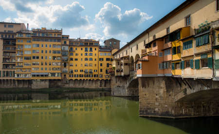 Ponte Vecchio landmark reflected on arno river. Florence, Tuscany Italy.の写真素材