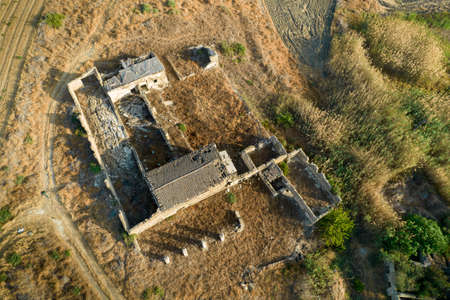 Abandoned and collapsing animal farm building in the field. Deserted places Cyprusの写真素材