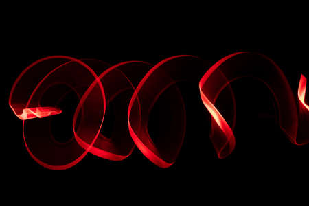 Red circle moving light trails on black background.