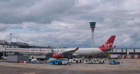 Airplane from Virgin Atlantic at London Heathrow airport in London. Aircraft is prepared for departure.のeditorial素材