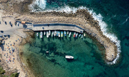 Aerial drone view of fishing boats moored at the harbor. moored at breakwater.の写真素材
