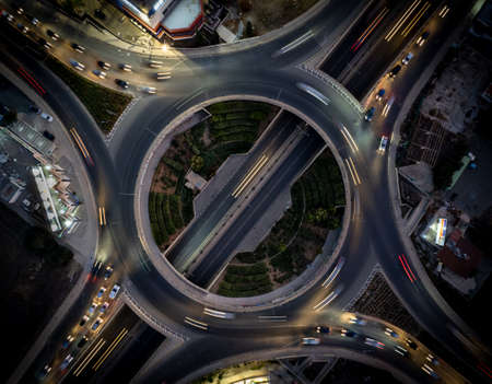 Aerial drone top view of a modern motorway junction roundabout with cars moving. Transportation infrastructure,の写真素材