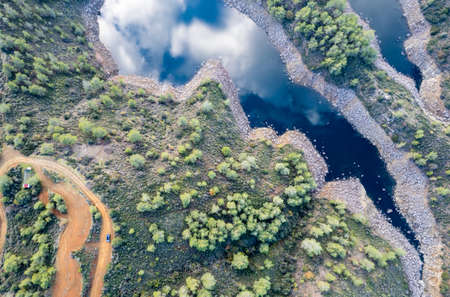 Aerial drone view of a dam full of water in the forest. Lefkara water reservoir Larnaca Cyprusの写真素材