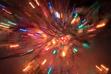 Colorful xmas blurred background with bright shiny lines of lightの写真素材