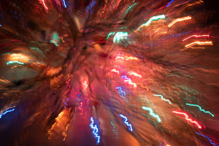 Colorful xmas blurred background with bright shiny lines of light