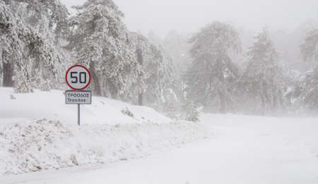 Icy slippery dangerous road in winter in the forest. Snowy mountains snowstorm.の写真素材