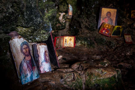 Interior of an old church cave with Christian saint pictures. Ayioi Saranta orthodox chapelのeditorial素材