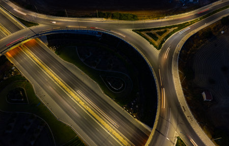 Aerial drone view of highway junction. Roundabout cars moving fast. Transportation infrastructureの写真素材