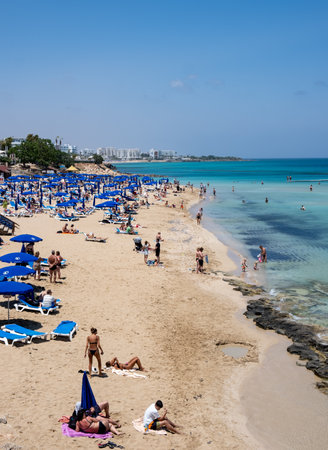 Tourist people enjoying summer vacations, relaxing, sunbathe swimming. Protaras fig tree bay Cyprusのeditorial素材