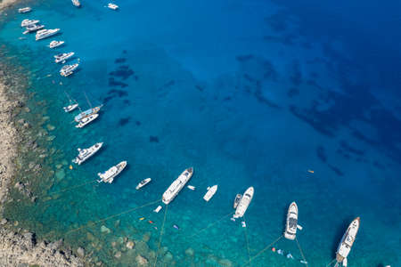 Drone aerial seascape luxury yachts moored in the coast and unrecognised people swimming relaxing. Summer vacations in the sea. Ayia Napa Cyprusの写真素材