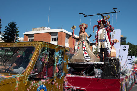 Happy people in teams dressed with colourful costumes parading at famous limassol carnival parade in...