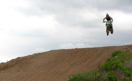Motorcycle rider athlete jumping on motocross racing outdoor . Extreme stortsの写真素材