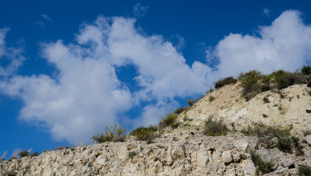 Mountain cliff wild terrain and blue cloudy sky.の写真素材