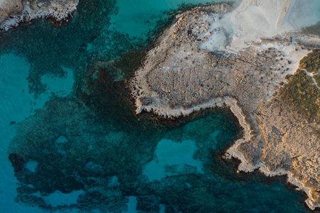 Aerial drone view of the rocky coastline island in winter.