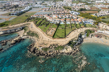 Drone aerial of holiday village with luxury houses at an idyllic rocky coast. Summer vacations at the sea.の写真素材