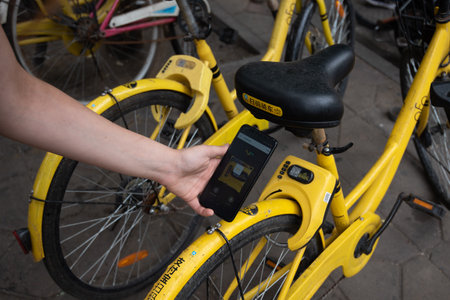 Person renting a bicycle with a mobile application. Urban transportation, eco friendly sustainable...