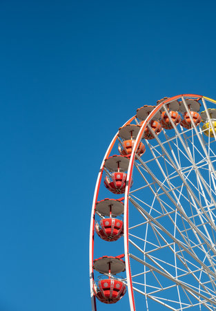Ferris wheel isolated on blue sky background, Having fun on an amusement fairground parkの写真素材