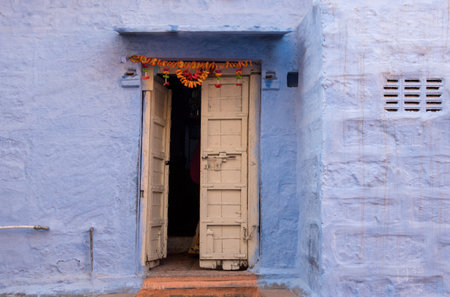 Facade of a traditional Indian blue house courtyard with white door. Indian home architectureの写真素材