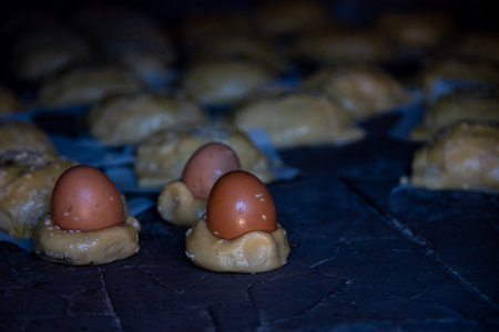 Traditional Cypriot easter cheese pastries flaounes and eggs cooked on a clay ovenの写真素材