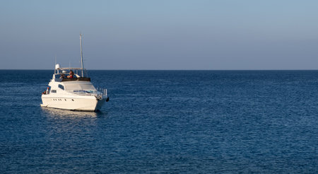 Tourist yachts with people sailing in the sea. Summer holidays in the ocean.のeditorial素材