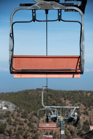 Empty ski lift for transporting skiers at snow slope for skiing in winterの写真素材