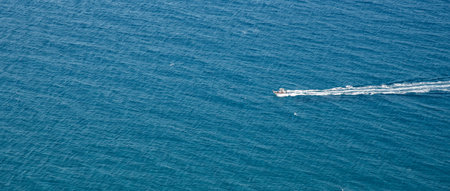 People having fun with water sports in the sea at summer holidaysの写真素材
