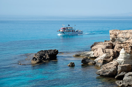 Tourist yacht sailing in the sea with tourists enjoying summer holidays and doing sightseeingのeditorial素材